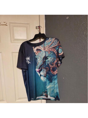 teal and green athletic shirt with a Diamond covered lion wearing a crown with a
